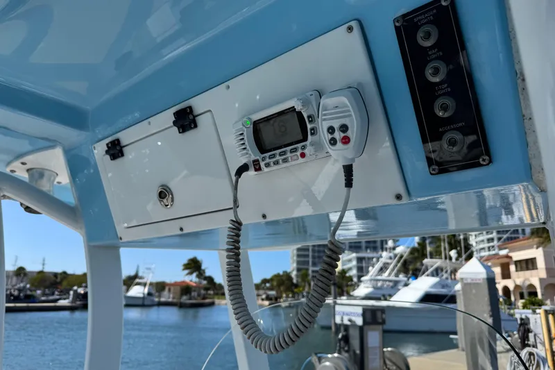 Slide: The Image of 2022 Sea Pro 259 Center Console boat dashboard with radio and control panel. - 15