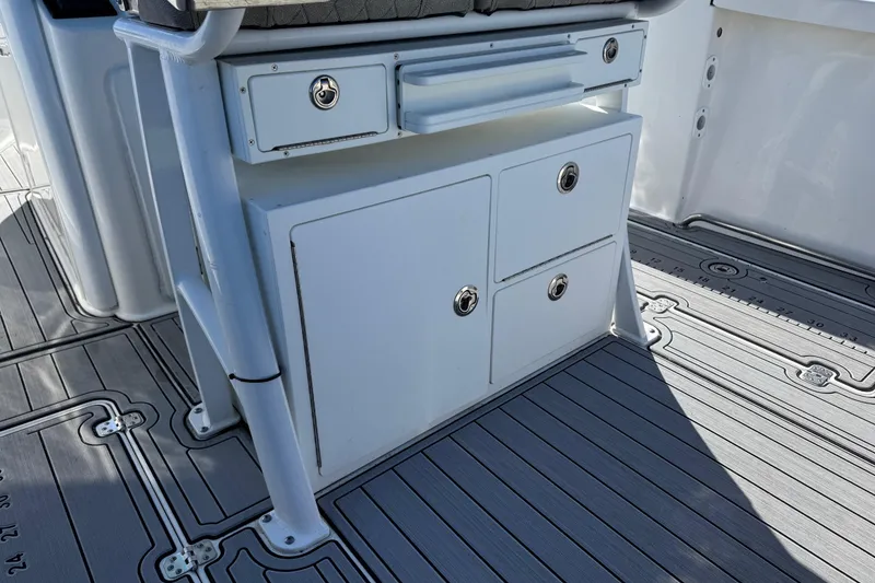 Slide: The Image of 2022 Sea Pro 259 Center Console storage area with drawers and non-slip deck. - 17