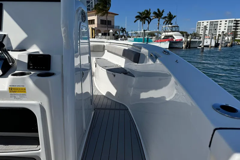 Slide: The Image of 2022 Sea Pro 259 Center Console boat docked, showcasing sleek design and spacious deck. - 20