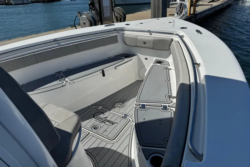 Slide: The Image of 2022 Sea Pro 259 Center Console boat interior with cushioned seating and sleek design. - 21