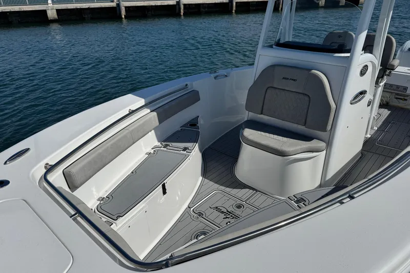 Slide: The Image of 2022 Sea Pro 259 Center Console boat interior with seating and storage, dockside view. - 23