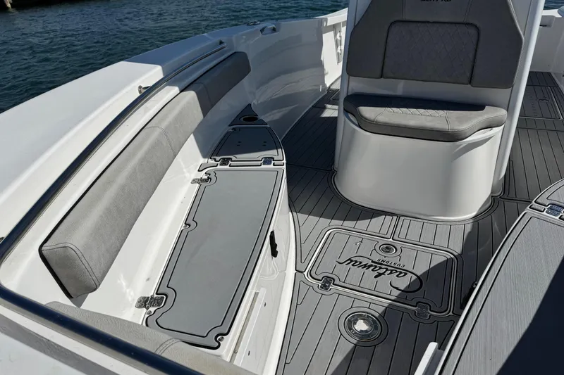 Slide: The Image of 2022 Sea Pro 259 Center Console boat interior with cushioned seating and custom flooring. - 24