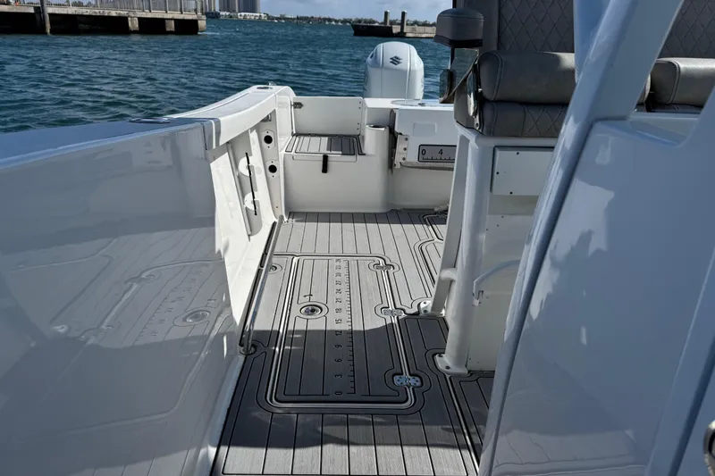 Slide: The Image of 2022 Sea Pro 259 Center Console boat interior with sleek deck design and seating. - 27