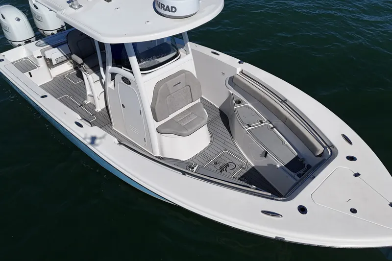 Slide: The Image of 2022 Sea Pro 259 Center Console boat on water, showcasing sleek design and spacious deck. - 6