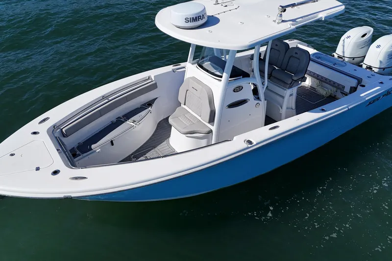 Slide: The Image of 2022 Sea Pro 259 Center Console boat on water, featuring dual engines and spacious seating. - 7