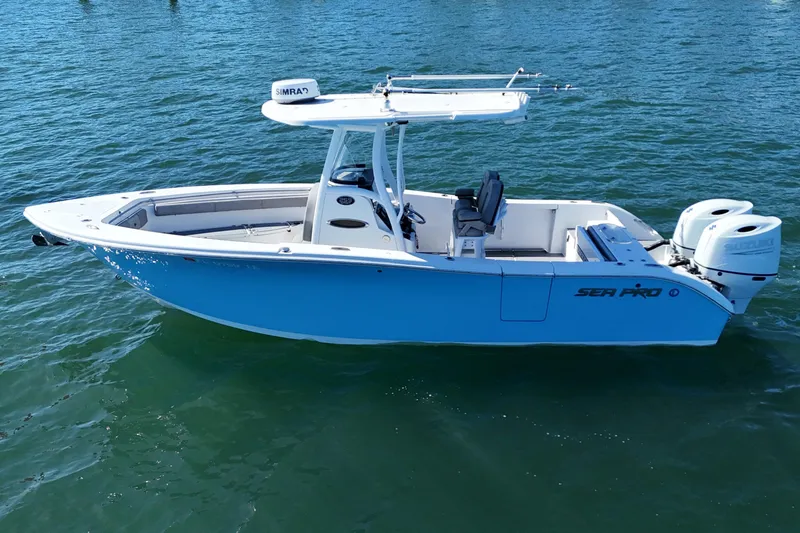 Slide: The Image of 2022 Sea Pro 259 Center Console boat on water, featuring dual engines and sleek design. - 9