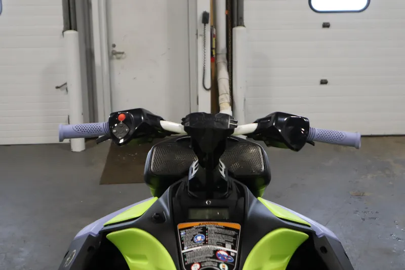 Slide: The Image of 2024 Sea-Doo Spark Trixx 3up handlebars in a garage setting. - 11