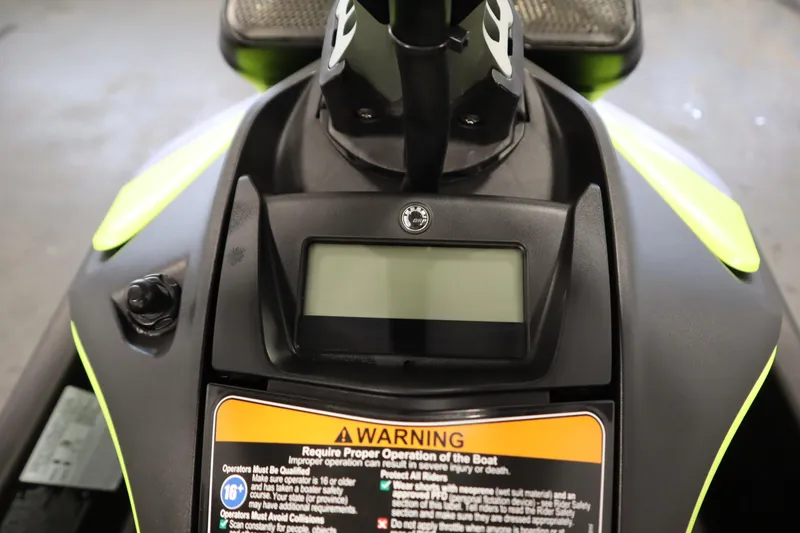 Slide: The Image of 2024 Sea-Doo Spark Trixx 3up dashboard with warning label and display screen. - 13