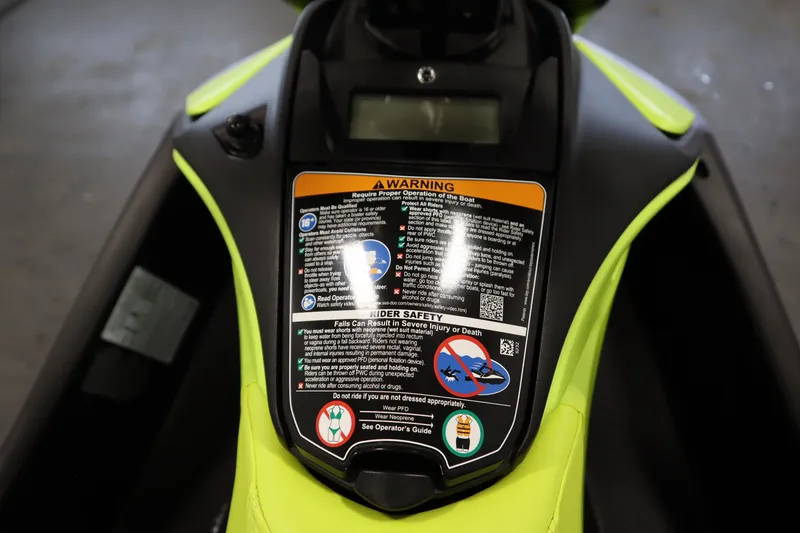 Slide: The Image of 2024 Sea-Doo Spark Trixx 3up dashboard with safety warnings and instructions. - 14