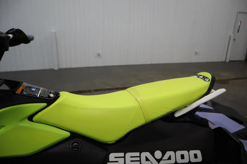 Slide: The Image of 2024 Sea-Doo Spark Trixx 3up with vibrant lime green seat in a showroom. - 16