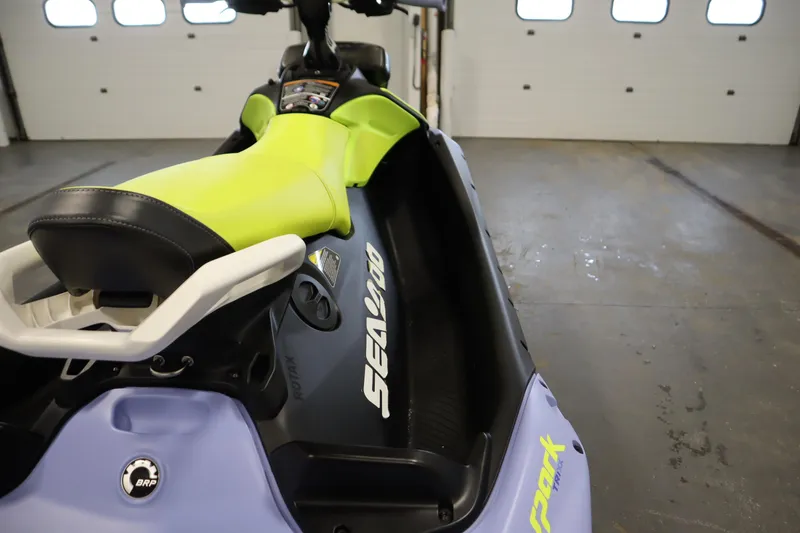 Slide: The Image of 2024 Sea-Doo Spark Trixx 3up with vibrant lime seat in a garage setting. - 17