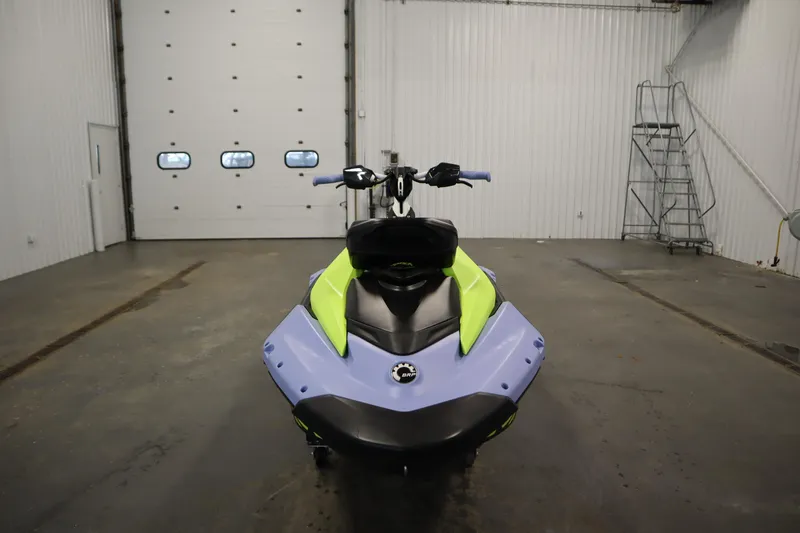 Slide: The Image of 2024 Sea-Doo Spark Trixx 3up in a garage, front view. - 2