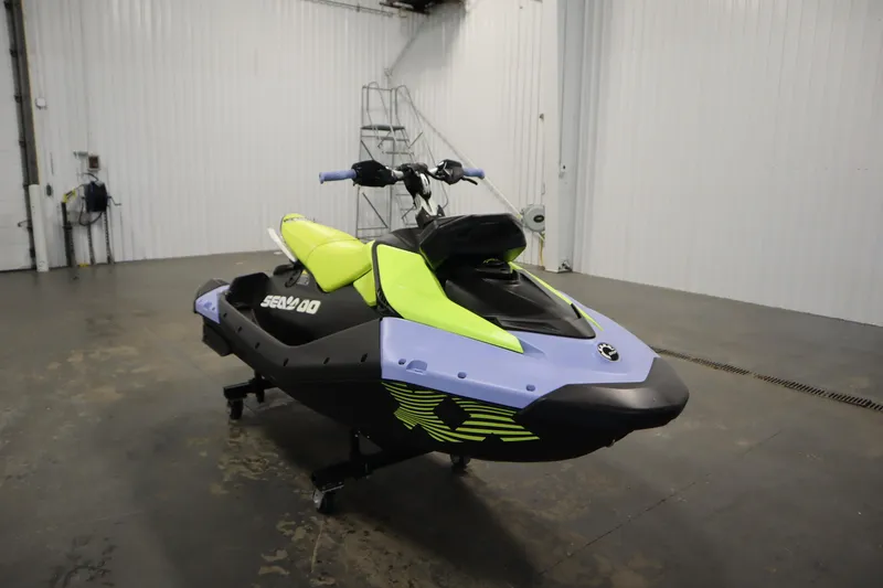 Slide: The Image of 2024 Sea-Doo Spark Trixx 3up in a showroom, featuring vibrant colors and sleek design. - 3
