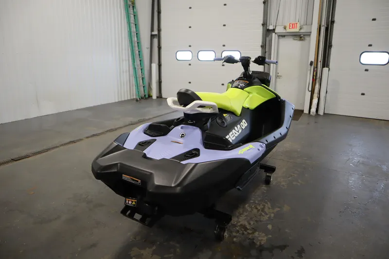 Slide: The Image of 2024 Sea-Doo Spark Trixx 3up jet ski in a garage setting. - 5