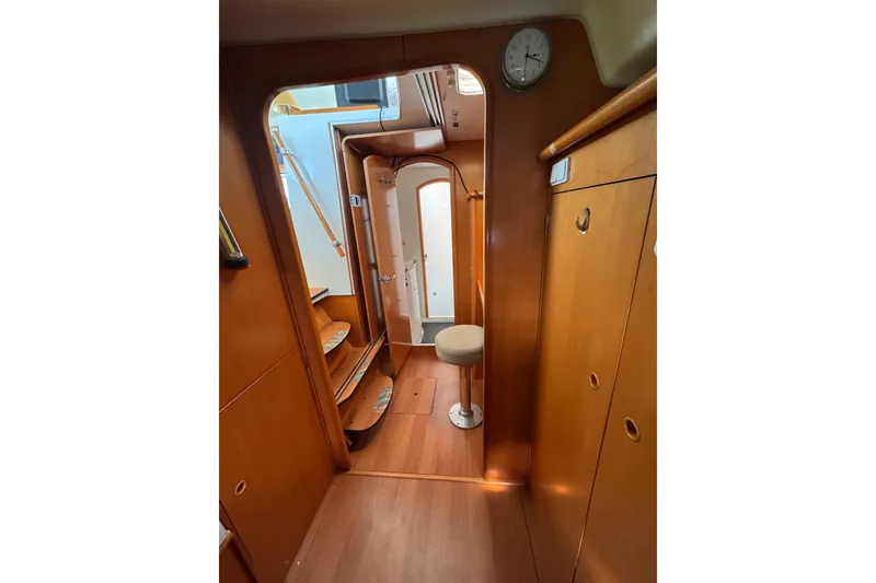 Slide: The Image of Interior of 2006 Lagoon 380 catamaran with wooden cabinetry and steps. - 15