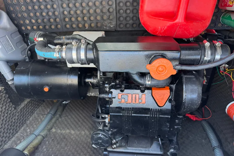 Slide: The Image of Engine compartment of a 2006 Lagoon 380 catamaran, featuring a Focs engine. - 27