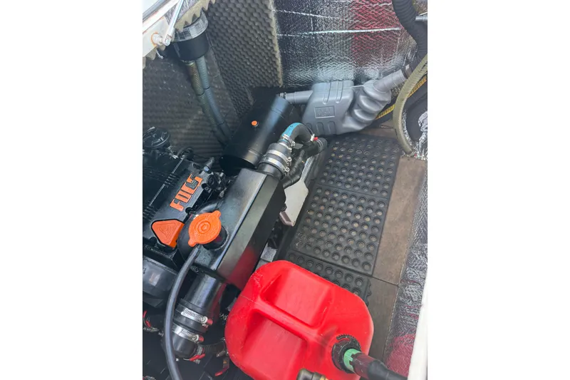 Slide: The Image of Engine compartment of a 2006 Lagoon 380 catamaran with visible components and red fuel container. - 28