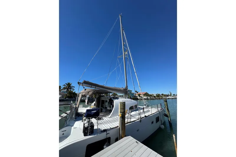 Slide: The Image of 2006 Lagoon 380 catamaran docked under clear blue sky. - 3