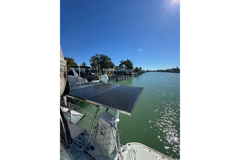 Slide: The Image of Lagoon 380 catamaran with solar panel, docked by a sunny waterfront, 2006 model. - 6