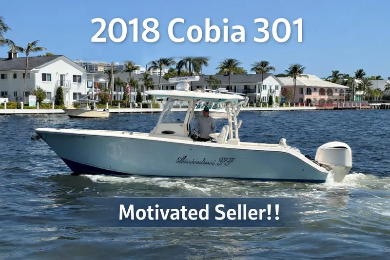 The Image of 2018 Cobia 301 Center Console boat on water, motivated seller, coastal background. - 0