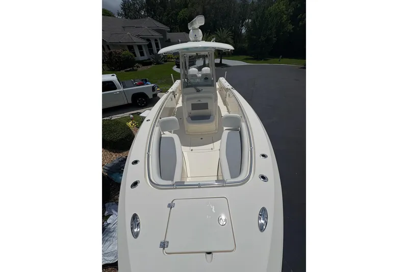 Slide: The Image of 2018 Cobia 301 Center Console boat with spacious deck and seating. - 16