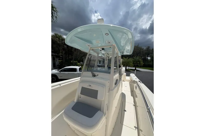 Slide: The Image of 2018 Cobia 301 Center Console boat with sleek design under cloudy sky. - 26