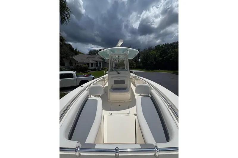 Slide: The Image of 2018 Cobia 301 Center Console boat with sleek design under cloudy sky. - 29