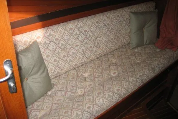 Slide: The Image of Cushioned seating area on a 1990 Nordhavn 46 yacht with patterned upholstery and pillows. - 15