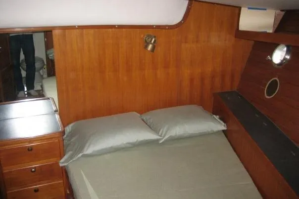 Slide: The Image of Cozy cabin interior of 1990 Nordhavn 46 yacht with wooden paneling and bed. - 16