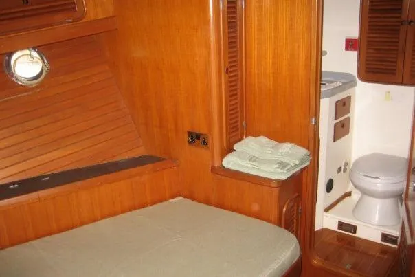 Slide: The Image of 1990 Nordhavn 46 yacht interior with wooden cabin and compact bathroom. - 17