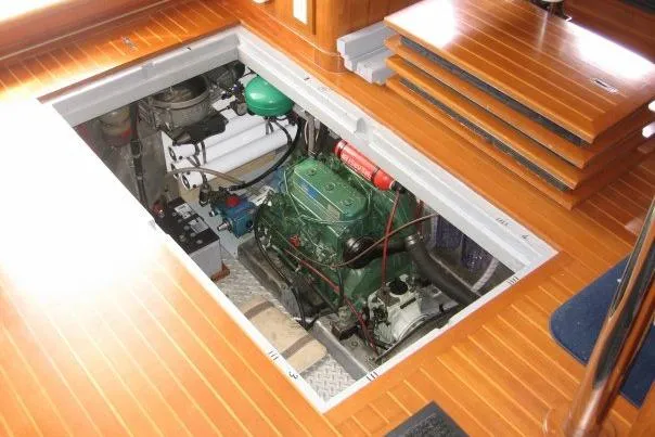 Slide: The Image of Engine room of 1990 Nordhavn 46 yacht with visible machinery and wooden flooring. - 19