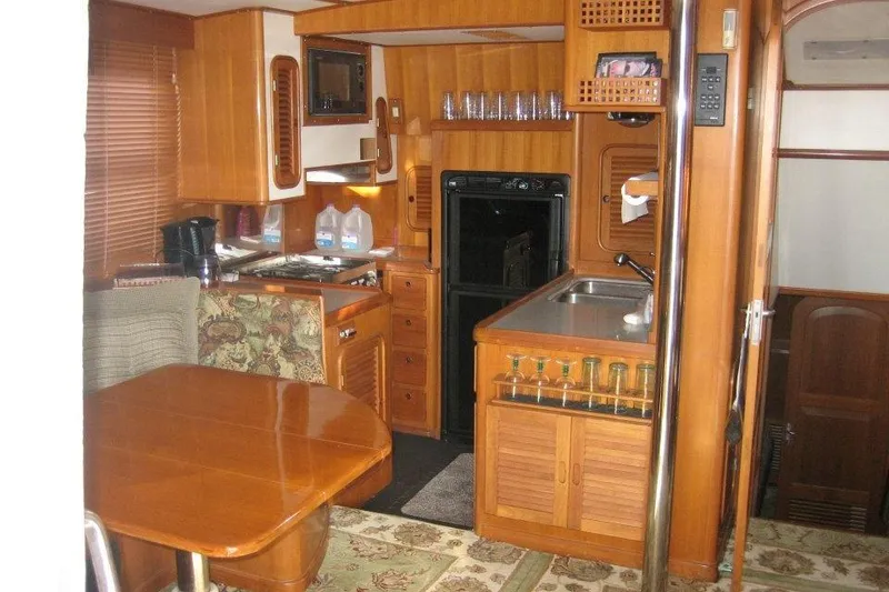 Slide: The Image of Interior of 1990 Nordhavn 46 yacht with wooden cabinetry and dining area. - 2