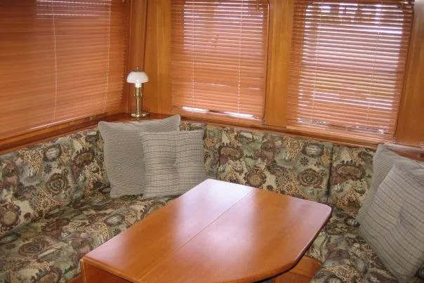 Slide: The Image of Cozy interior of 1990 Nordhavn 46 yacht with patterned seating and wooden table. - 3