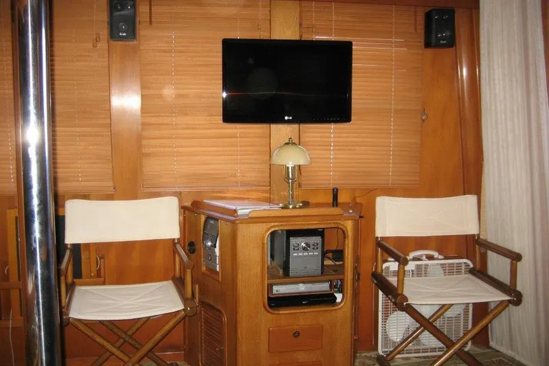 Slide: The Image of Interior of 1990 Nordhavn 46 yacht with chairs, TV, and wooden paneling. - 4