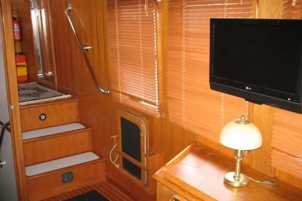 Slide: The Image of Interior of 1990 Nordhavn 46 yacht with wooden paneling, TV, and lamp. - 5
