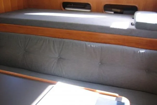 Slide: The Image of Interior seating of 1990 Nordhavn 46 yacht with gray cushions and wooden accents. - 8