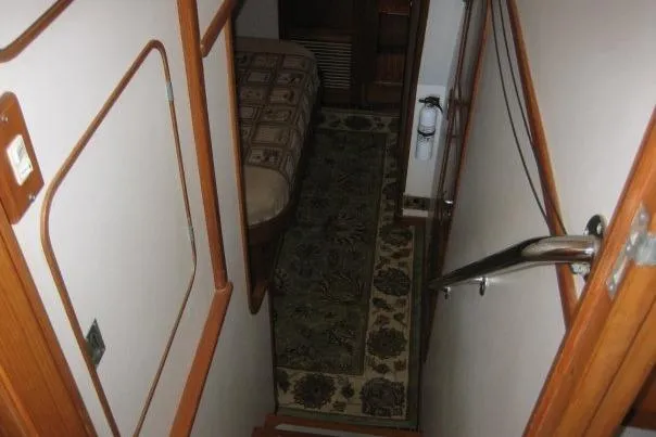 Slide: The Image of Stairway leading to cabin interior of 1990 Nordhavn 46 yacht, featuring patterned carpet. - 9