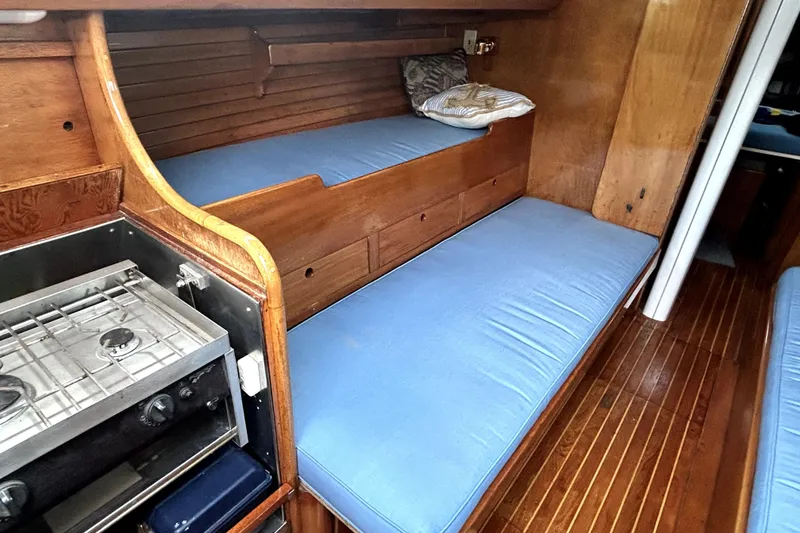 Slide: The Image of Interior of 1969 Hinckley 38 sailboat with blue cushions and compact stove. - 20