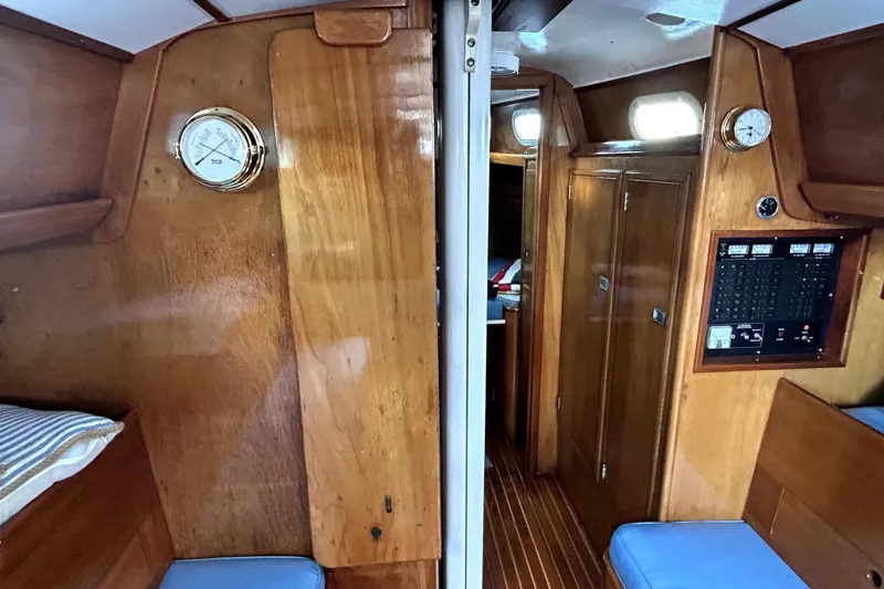Slide: The Image of Interior of a 1969 Hinckley 38 sailboat with wooden paneling and nautical instruments. - 27