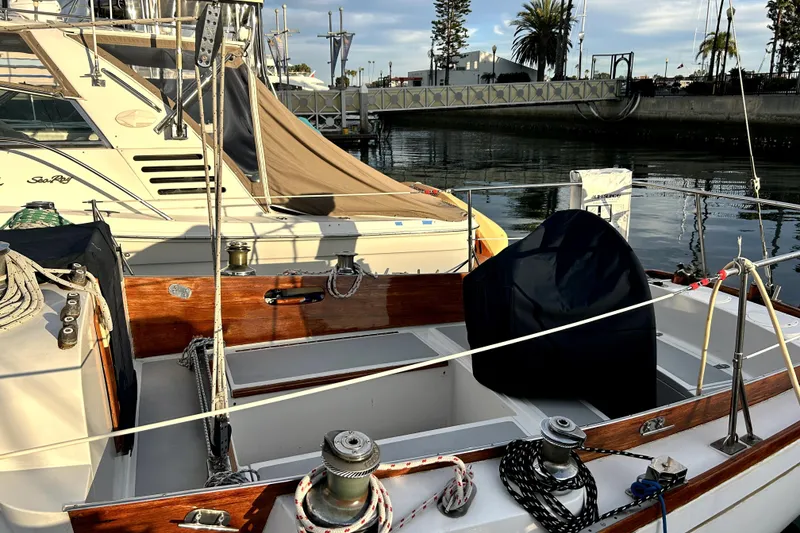 Slide: The Image of 1969 Hinckley 38 sailboat docked, featuring wooden accents and nautical equipment. - 9
