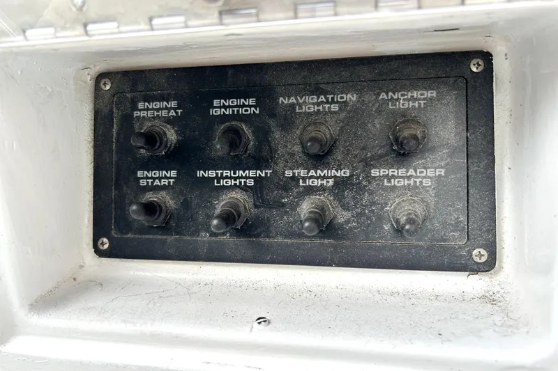 Slide: The Image of Control panel of a 1969 Hinckley 38 boat with labeled switches. - 16