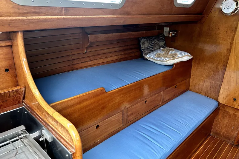 Slide: The Image of Interior of 1969 Hinckley 38 sailboat with wooden finish and blue cushions. - 19