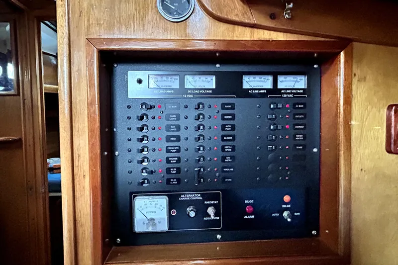 Slide: The Image of Electrical control panel on a 1969 Hinckley 38 yacht, featuring various switches and gauges. - 23