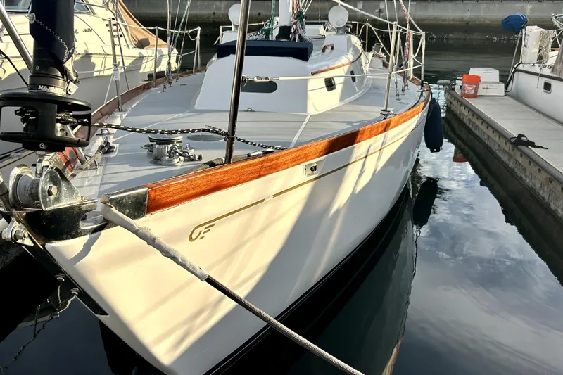 Slide: The Image of Hinckley 38 sailboat from 1969 docked at a marina, showcasing classic design. - 5