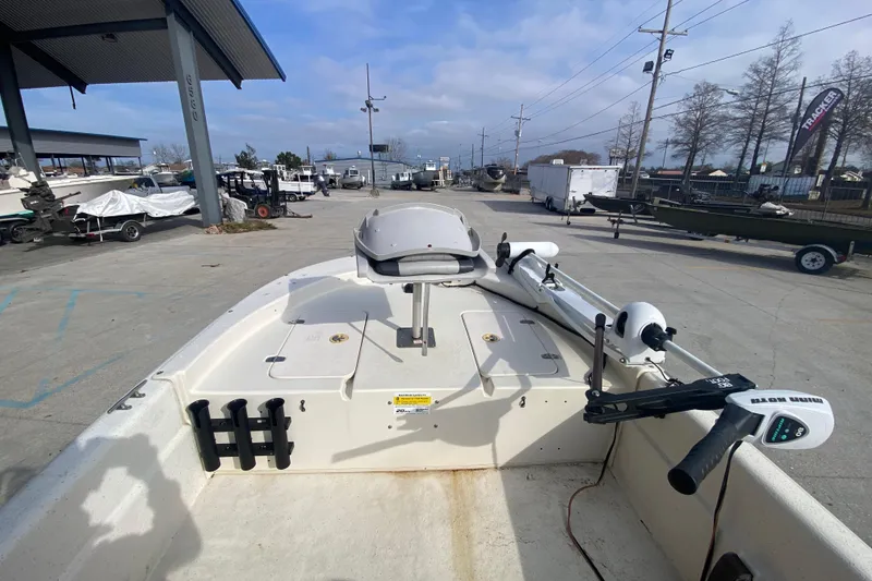 Slide: The Image of 2015 Carolina Skiff 20 JVX CC boat with trolling motor at a marina. - 11