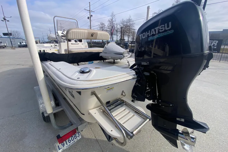 Slide: The Image of 2015 Carolina Skiff 20 JVX CC boat with Tohatsu outboard motor, parked on trailer. - 20