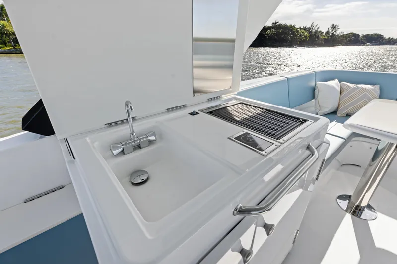 Slide: The Image of Luxurious 2026 Cruisers 50 Fly yacht with outdoor sink and grill on deck. - 18