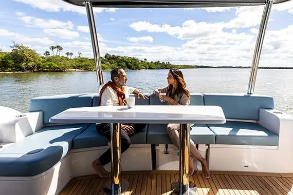 Slide: The Image of Couple enjoying conversation on 2026 Cruisers 50 Fly yacht, scenic water view. - 23