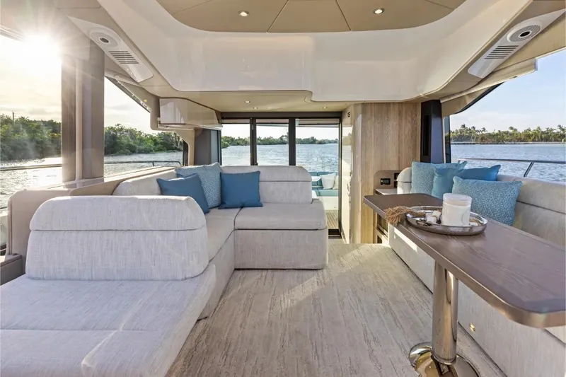 Slide: The Image of Luxurious interior of 2026 Cruisers 50 Fly yacht with elegant seating and scenic water view. - 36