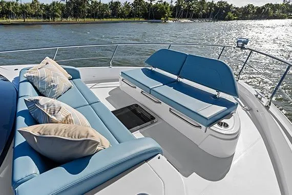 Slide: The Image of Luxurious 2026 Cruisers 50 Fly yacht deck with plush seating and scenic water view. - 40